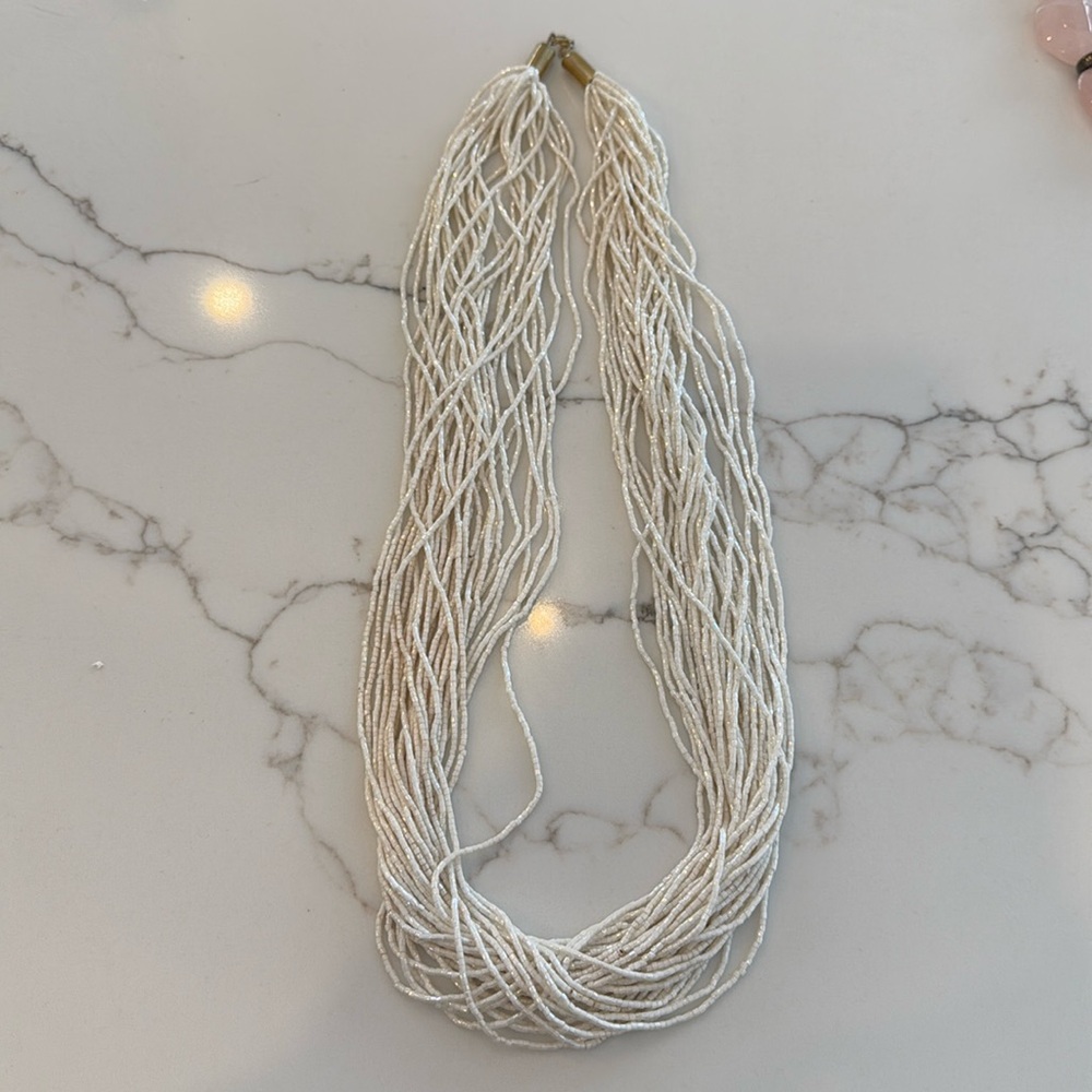 Used: White glass bead necklace, metal clasp